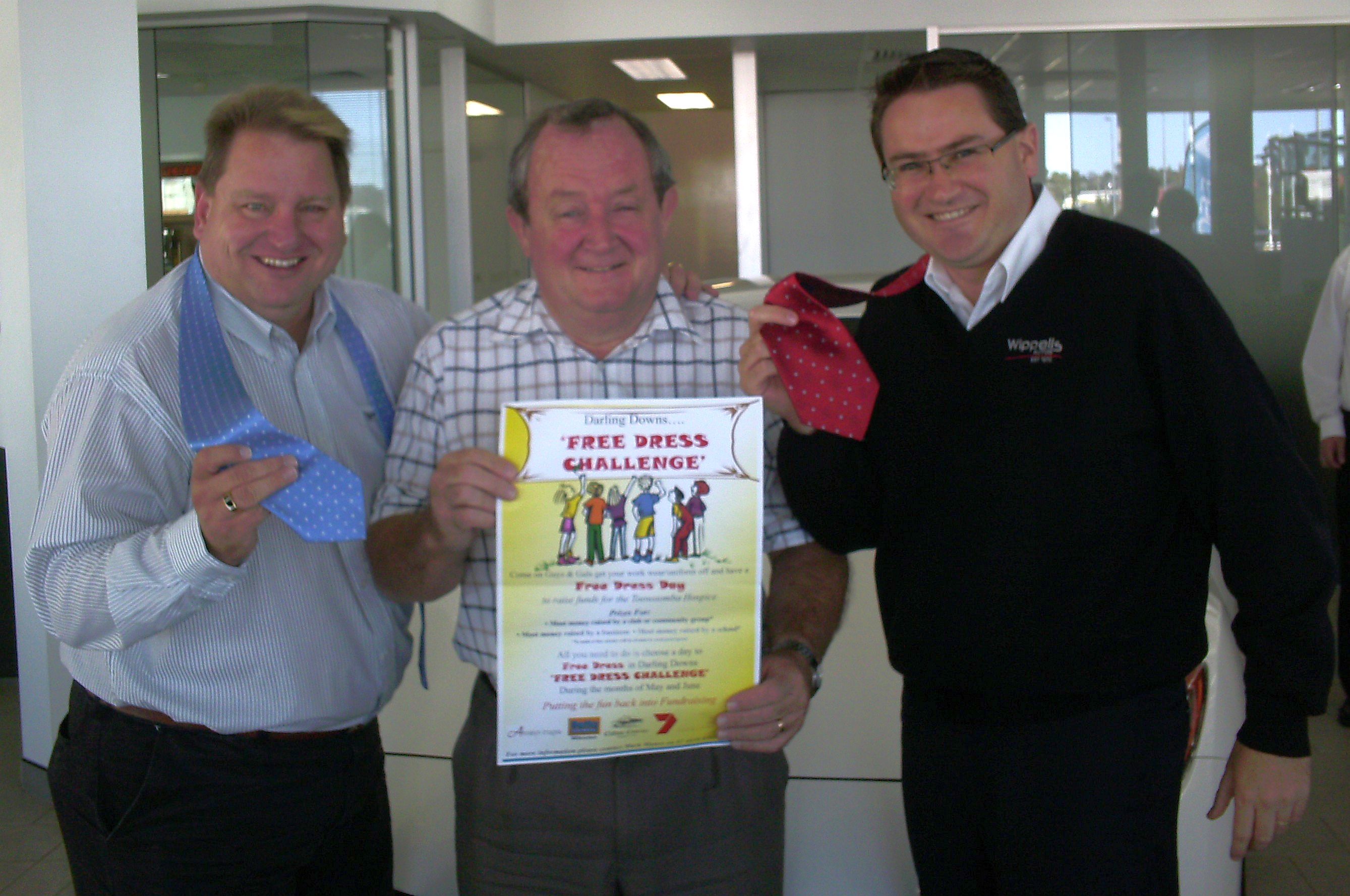 L to R: Mark Munro, Graham Barron both from Toowoomba Hospice encourage Wippells Dealer Principal Dave Russell to get his tie off in support of the Annual Darling Downs Free Dress Challenge.