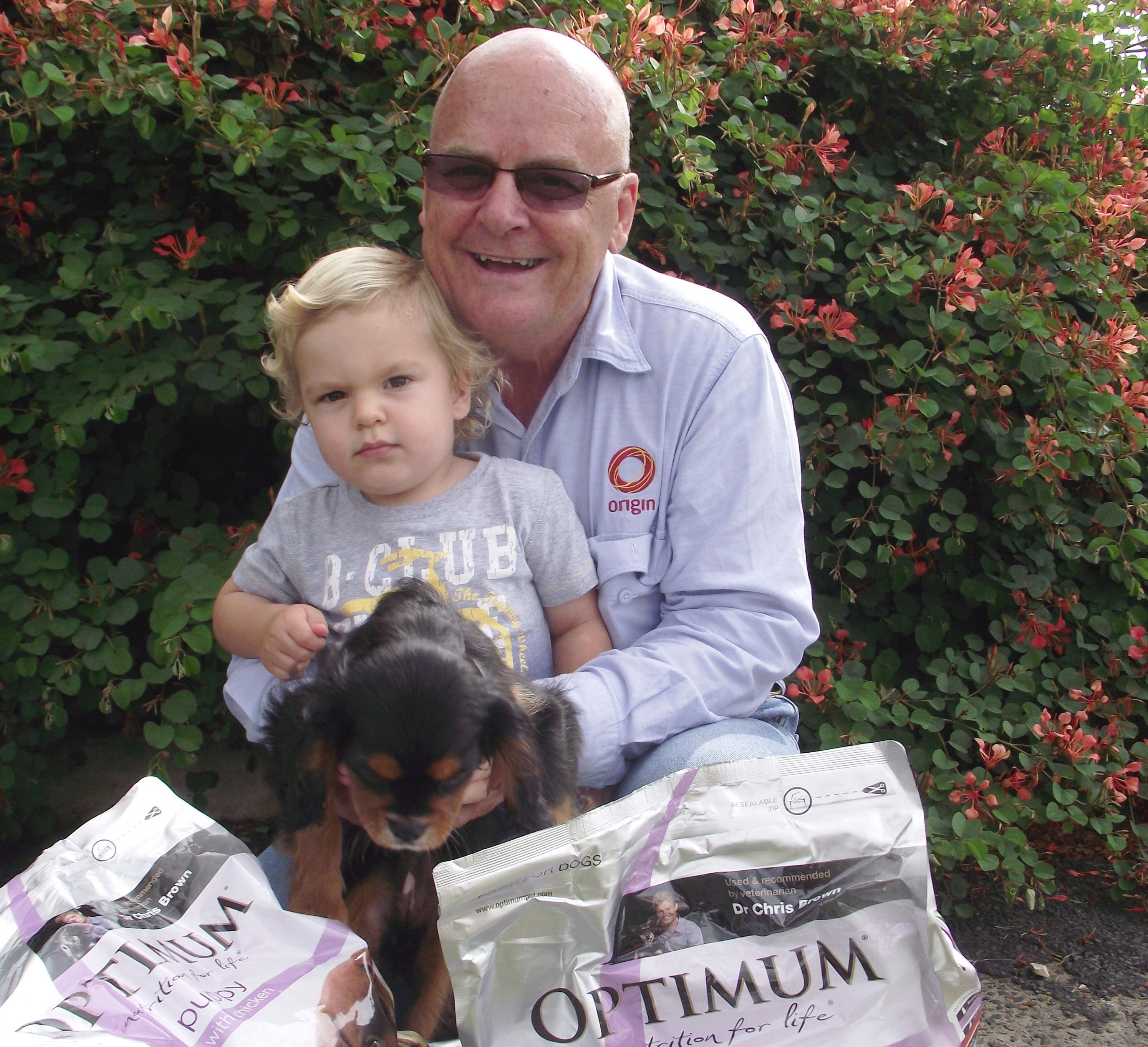 Origin Holiday Pet Food Drive launch Origin's Bruce Chalmers with Alfonse and puppy 101210-1