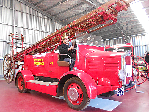 President of the Toowoomba Fire Brigade Historical Society, Lester Naumann, at the wheel of a restored fire engine